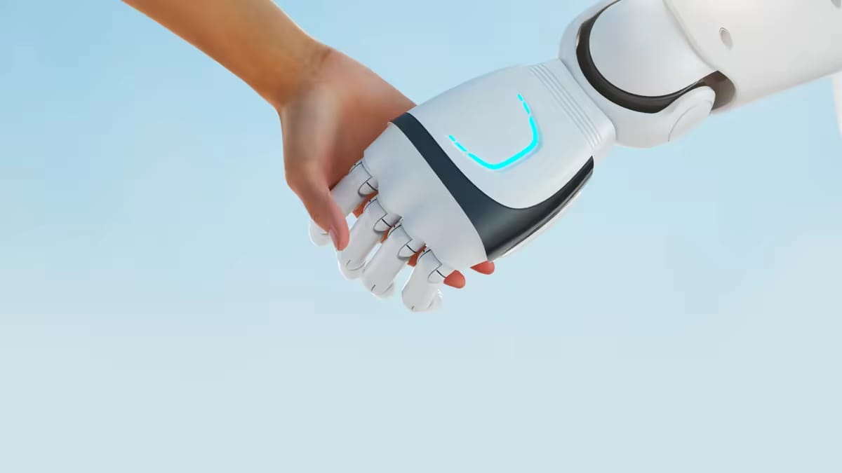 Človeška roka in robotova dlan se držita.